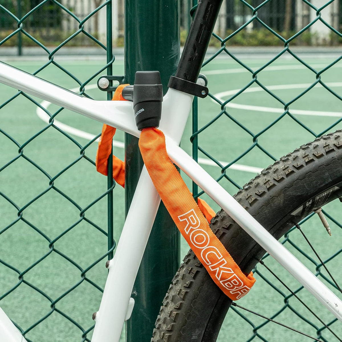ROCKBROS candado de cadena para bicicleta naranja fijado a bicicleta y cerca metálica
